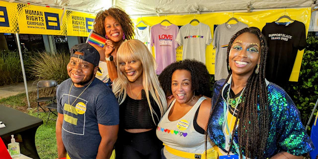 HRC Pride booth at South Florida's pride event, group of volunteers are posed behind the table