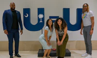 Group of people standing in front of a U=U sign