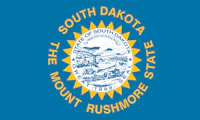 State flag of South Dakota. Outer circle of text reads "SOUTH DAKOTA THE MOUNT RUSHMORE STATE" middle circle of text reads "GREAT STATE OF SOUTH DAKOTA SEAL 1889" innermost circle of text reads "UNDER GOD THE PEOPLE RULE"