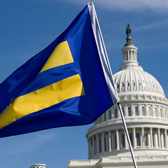 United States Capitol in the background with the HRC equality flag.