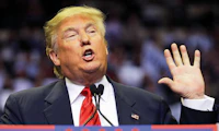 Donald Trump with his hand raised.